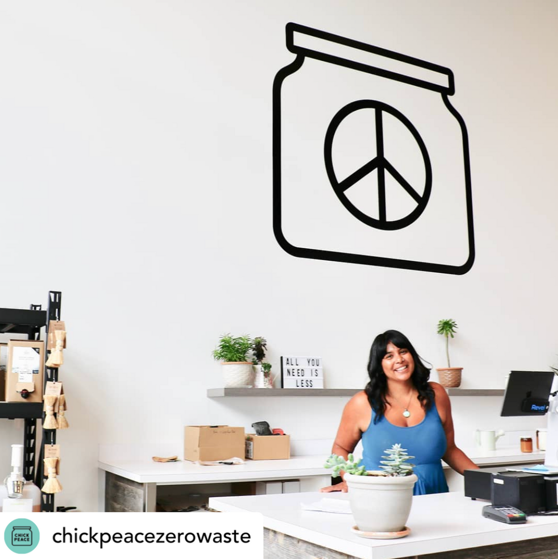 Allisha smiling behind the counter at Chickpeace. 